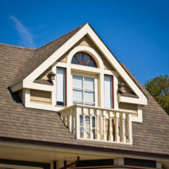 A prominent dormer balcony in the Victorian style.